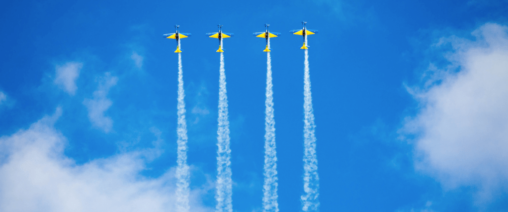 Nascidos em fevereiro recebem a quarta parcela do auxílio emergencial 2021 hoje, 18 de julho. Céu azul, nuvens brancas, e quatro aviões de fumaça, um ao lado do outro, formando 4 riscos de fumaça no céu. Créditos: Gabriel Gusmao, Unsplas